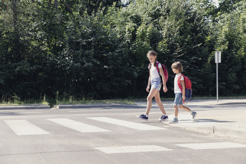 children walking to school in crosswalk