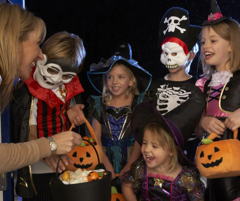 smiling children in costumes trick or treating